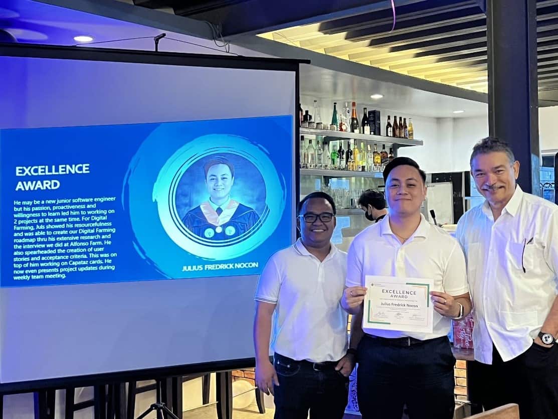 A few men holding a certificate

Description automatically generated with medium confidence